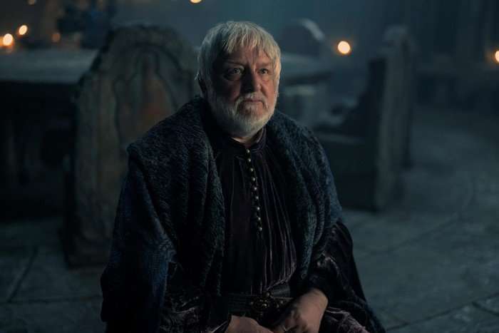 Sir Simon Russell Beale as Ser Simon Strong in a dark interior setting in House of the Dragon.