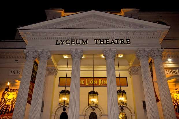Exterior of the Lyceum Theatre with signs for The Lion King