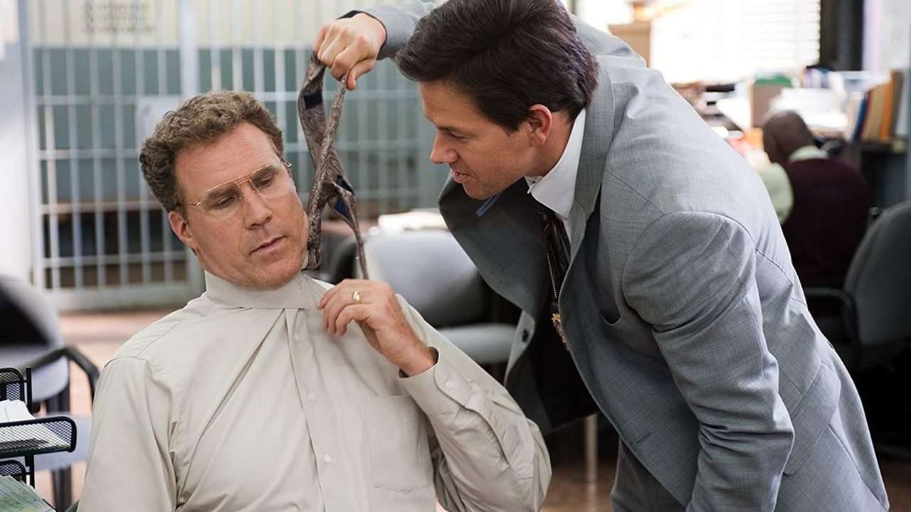 Mark Wahlberg pulling Will Ferrell's tie in a scene from The Other Guys.