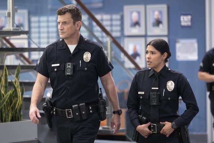 Nathan Fillion and Alyssa Diaz in The Rookie, walking through the police station
