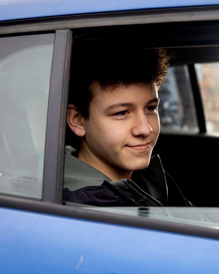 Will Driscoll sat in a car in a scene from Coronation Street