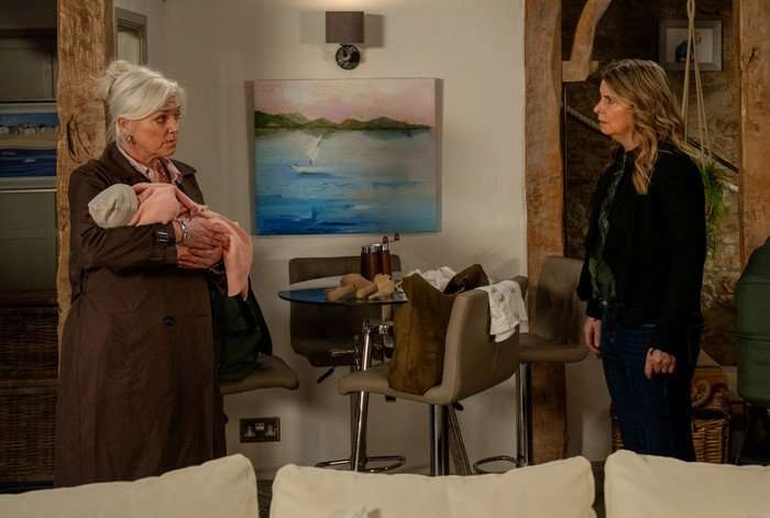 Charity is shocked to see Dr Todd holding Leyla in a scene from Emmerdale