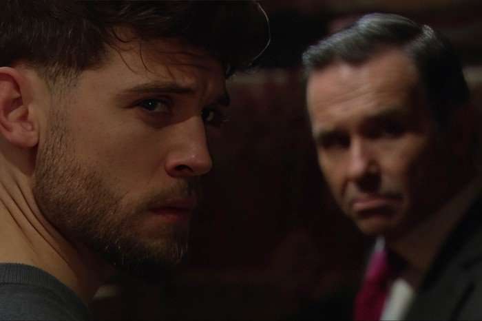 Joe and Graham look sideways in a scene from Emmerdale