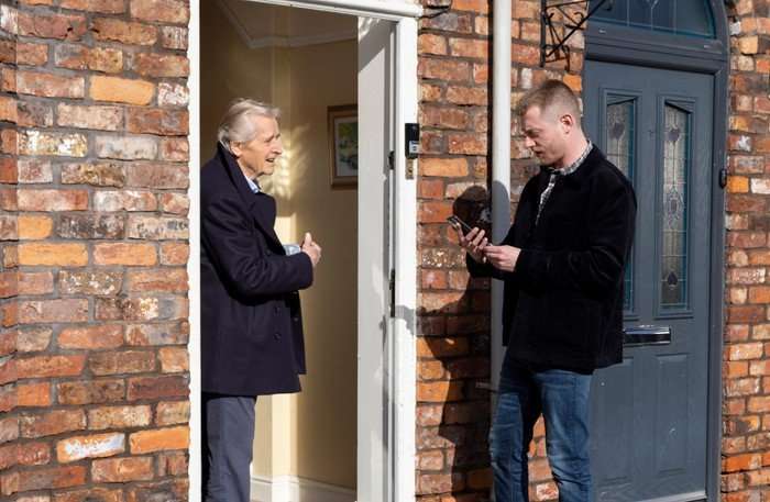 Daniel and Ken have a conversation at the front door of No. 1 Coronation Street