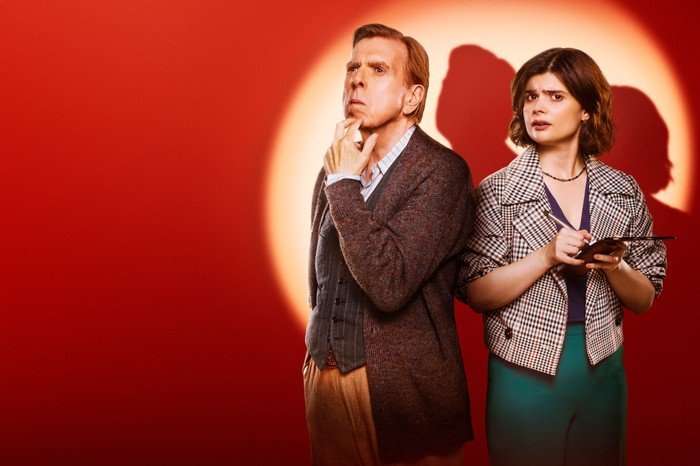Timothy Spall and Gwyneth Keyworth in Death Valley, in front of a red background with a spotlight on them
