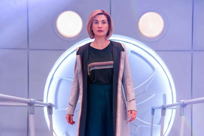 Jodie Whittaker as the Doctor in Doctor Who, stood in the TARDIS.
