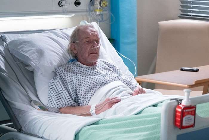 George stands at the foot of Eddie's bed in EastEnders