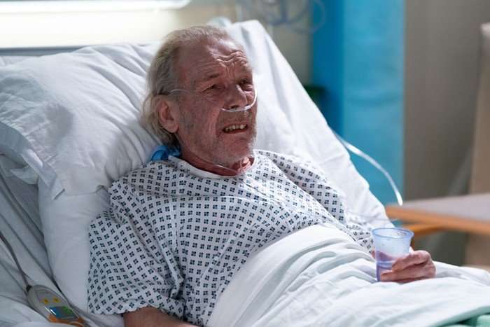 Eddie Knight lay in a hospital bed with tubes going into his nose in a scene from EastEnders