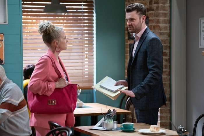 Linda and Johnny stood in the cafe in a scene from EastEnders