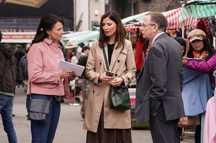 Ian and Honey stand either side of Bea in EastEnders