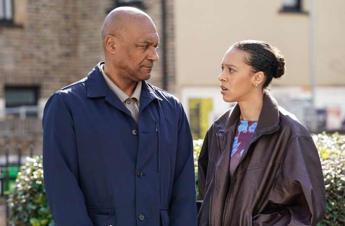 Gina and George look at one another in a scene from EastEnders