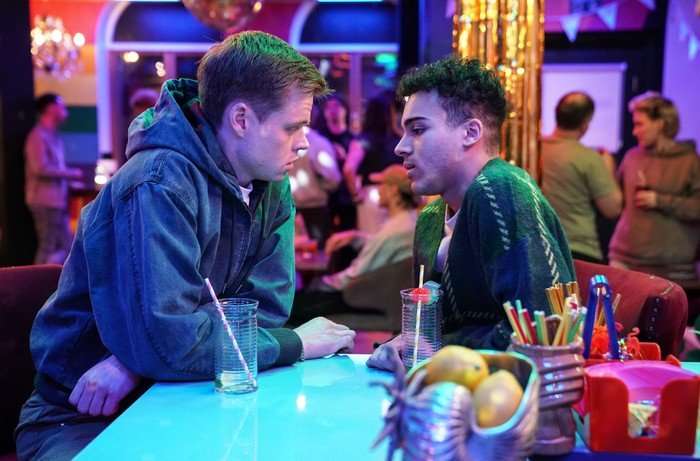Oscar and Josh lean in for a kiss in a scene from EastEnders