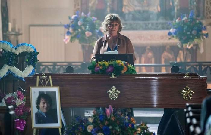 Julie delivers a eulogy in front of Nigel's coffin in EastEnders
