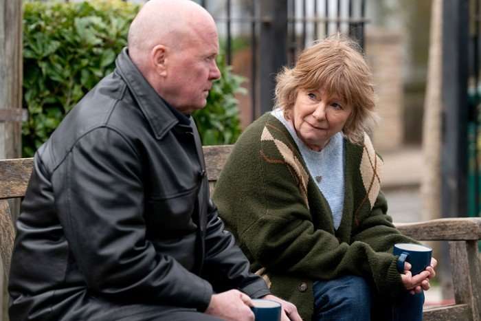 Phil and Julie sat on a bench in EastEnders.