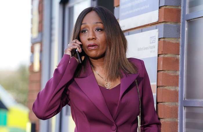 Denise on the phone outside of the hospital in EastEnders