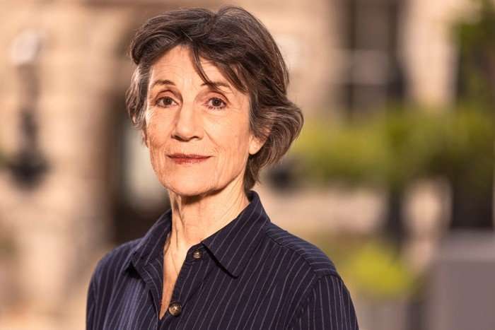 562222,TITLE:Who Do You Think You Are? s23 Harriet Walter smiling ahead with her body slightly turned to one side. She is wearing a stripy blue shirt.