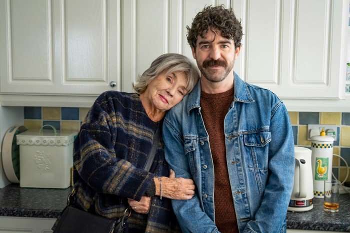 Sue leans her head affectionately on Michael's shoulder in an image from Ann Droid