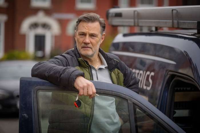 David Morrissey stars in Tip Toe; his character, Clive, is seen here leaning over the front door of his van on a residential street