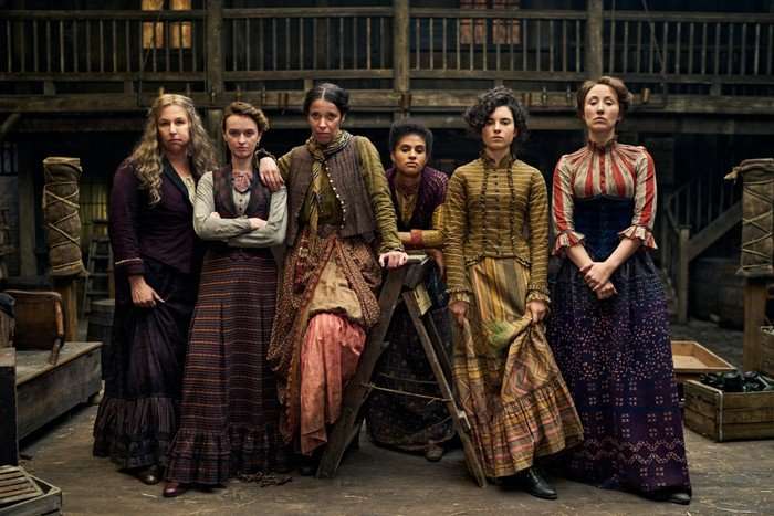 Hannah Walters as Eliza, Darci Shaw as Alice and Erin Doherty as Mary in A Thousand Blows season 2, stood with other members of the Forty Elephants.