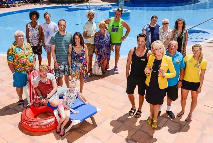 The cast of Benidorm, stood around a pool