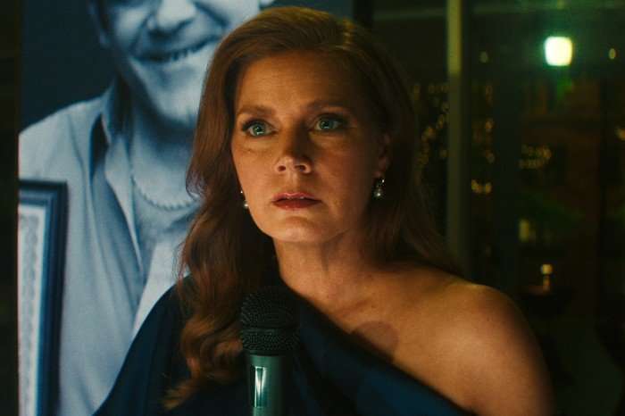 Amy Adams in Cape Fear, holding a microphone and looking shocked.