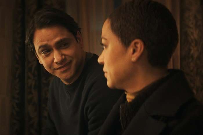 Criminal_Record_Photo_020205 Cush Jumbo and Luca Pasqualino in Criminal Record, sat together inside looking at one another.