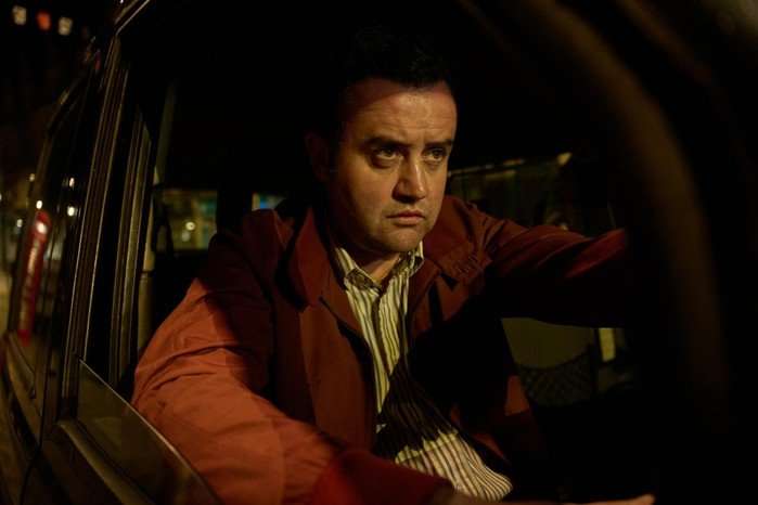 Daniel Mays as John Worboys in Believe Me, driving a taxi.
