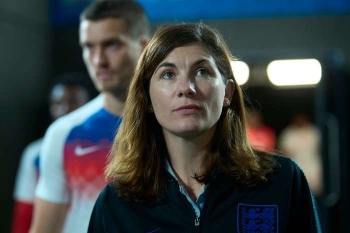 Jodie Whittaker as psychologist Pippa looking up in Dear England.