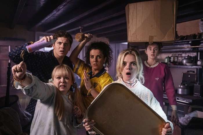 Derry Girls season 3 The main characters of Derry Girls holding various mundane household items in a comically defensive and panicked pose