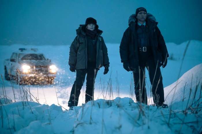 True Detective: Night Country Jodie Foster and Kali Reis stand in the snow, wearing heavy winter gear in a scene from True Detective: Night Country
