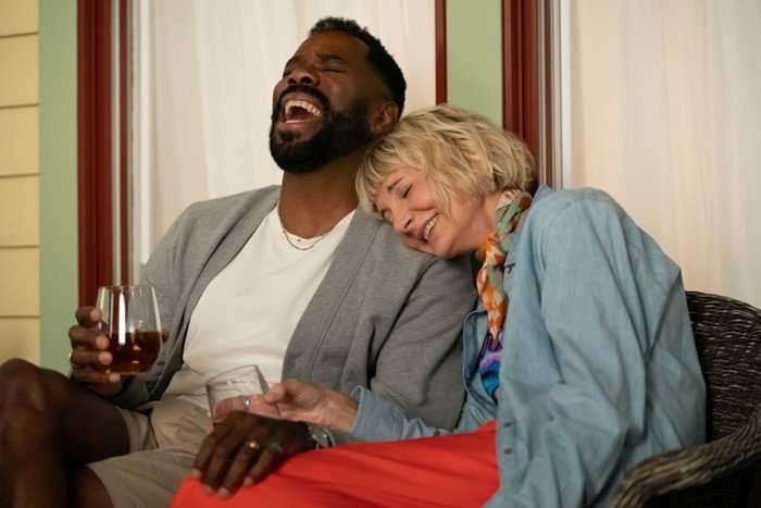 THE FOUR SEASONS, SEASON 2 Colman Domingo and Kerri Kenney-Silver in The Four Seasons season 2; their characters are sitting closely next to each other and laughing.