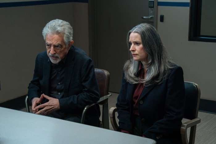 Joe Mantegna as David Rossi and Paget Brewster as Emily Prentiss in Criminal Minds: Evolution, sat behind a metal table together