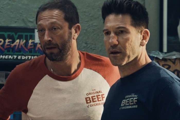 Jon Bernthal and Ebon Moss-Bachrach in Gary, both wearing T-shirt with The Original Beef of Chicago logo on, and looking shocked at something off screen.