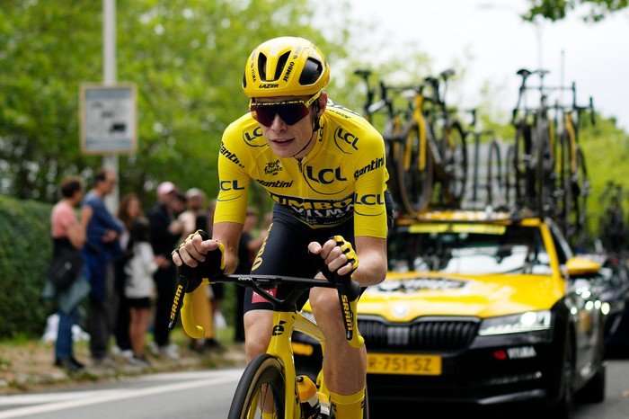 Cyclist Jonas Vingegaard, in full yellow, rides to victory at the Tour de France 2023.