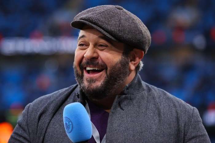 Manchester City v Newcastle United - Emirates FA Cup Quarter Final Adam Richman wearing a flat-cap, laughing in the direction of his co-hosts while presenting a Manchester City game.