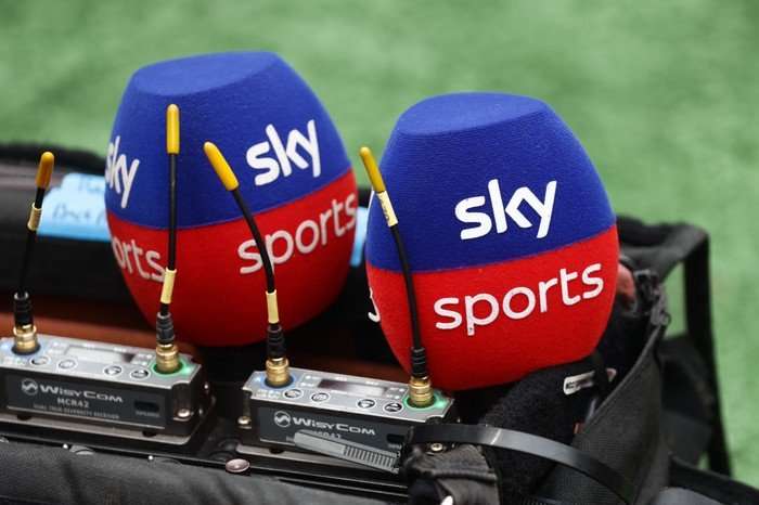 Two blue and red Sky Sports microphone muffs.