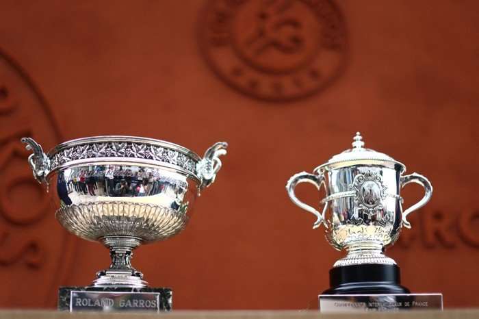 French Open 2026 seeded players The men's and women's French Open trophies in front of an orange background.