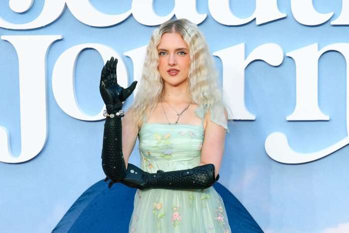 Eurovision-2026 Tilly Lockey holding her bionic arms in a 90 degree angle position and looking ahead.