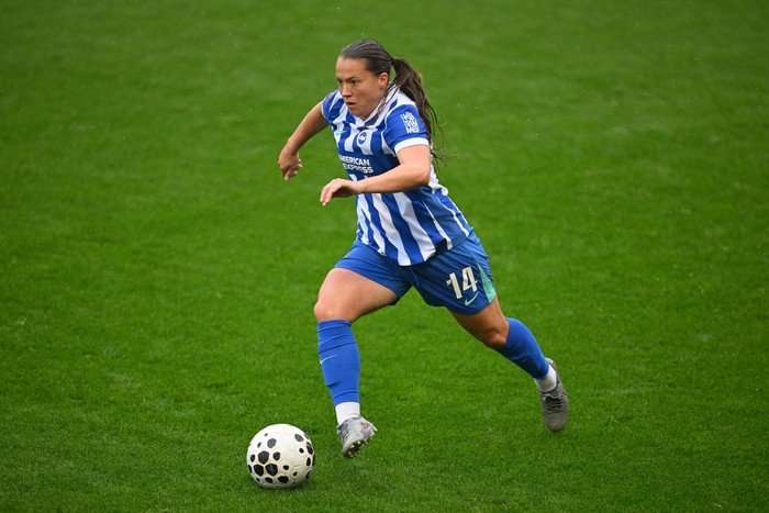 Brighton midfielder Fran Kirby Brighton midfielder Fran Kirby, in blue and white football kit, dribbles with the ball on the pitch.