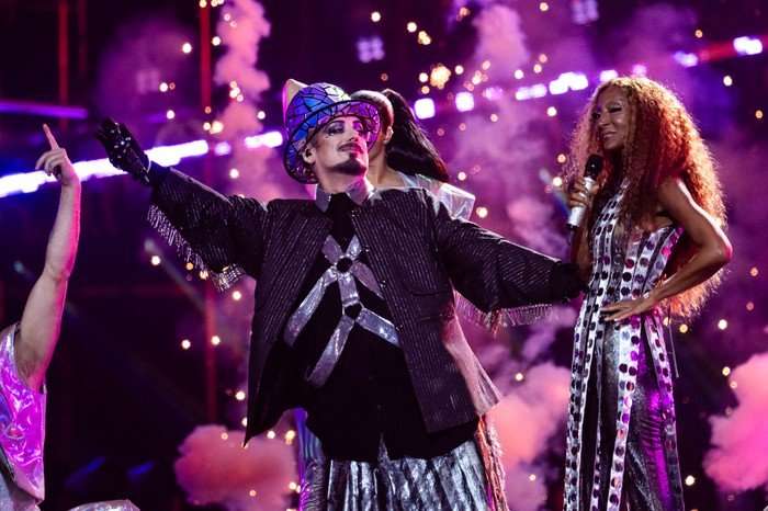 Senhit and Boy George stood next to each other performing on stage.