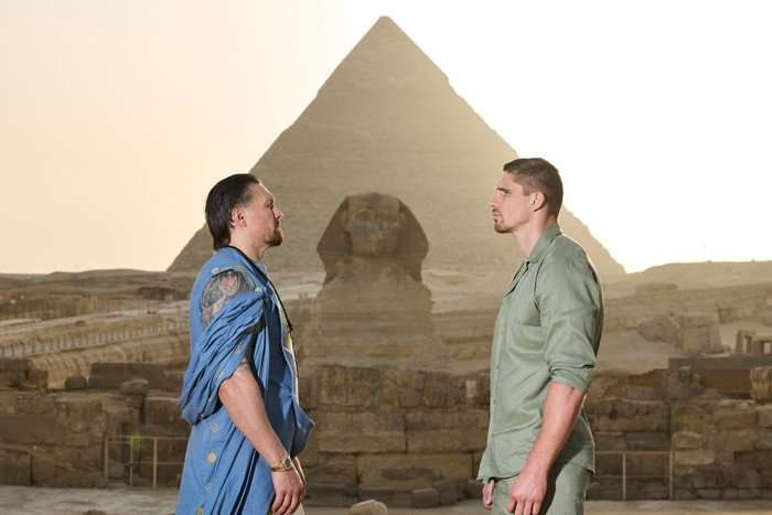 Oleksandr Usyk and Rico Verhoeven face off ahead of their boxing match with the Pyramids of Giza in the background.