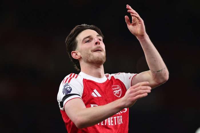 Arsenal Declan Rice Arsenal midfielder Declan Rice, in red and white football kit, celebrates on the pitch at the Emirates.