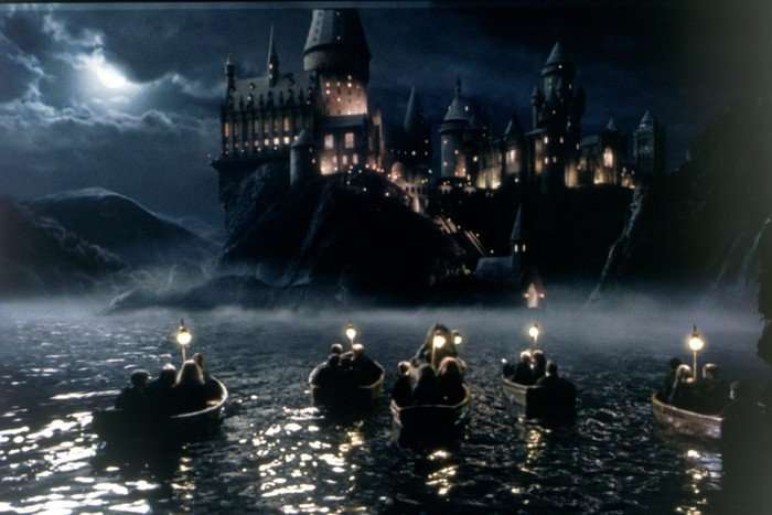 Hogwarts Castle in Harry Potter and the Philosopher's Stone Hogwarts Castle in Harry Potter and the Philosopher's Stone. The castle is seen at night from the lake, with rowboats approaching it.