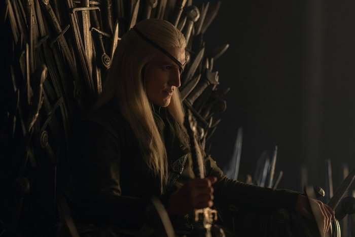 Ewan Mitchell as Aemond Targaryen in House of the Dragon season 3. Aemond Targaryen on the Iron Throne in House of the Dragon.
