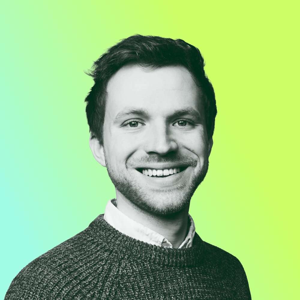 Black and white cut-out portrait headshot of James Hibbs, smiling against a lime green background.