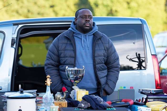 Ekow Quartey plays JJ, manning a car boot stall