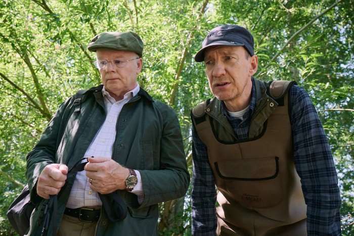 Dirty Business David Thewlis and Jason Watkins in Dirty Business, stood outside an looking down at something, concerned.