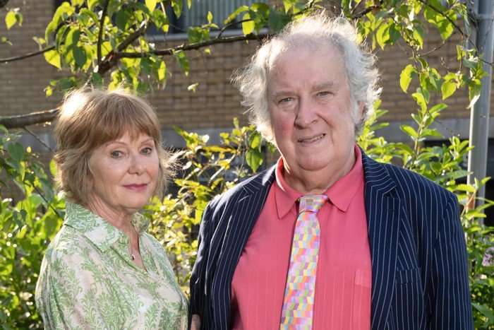 Julie and Nigel EastEnders Karen Henthorn and Paul Bradley as Julie and Nigel in EastEnders. She is wearing a flowery blouse and he's wearing a navy jacket with a pink shirt and tie.