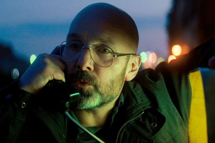 Johnny Harris as Eddie McKee in Legends, stood outside a speaking on a payphone.