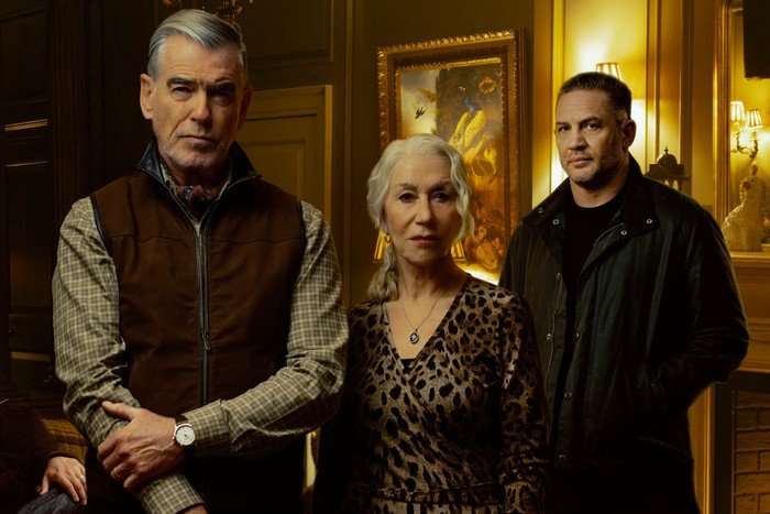 Mobland Pierce Brosnan as Conrad Harrigan, Helen Mirren as Maeve Harrigan and Tom Hardy as Harry Da Souza in MobLand stood looking into camera
